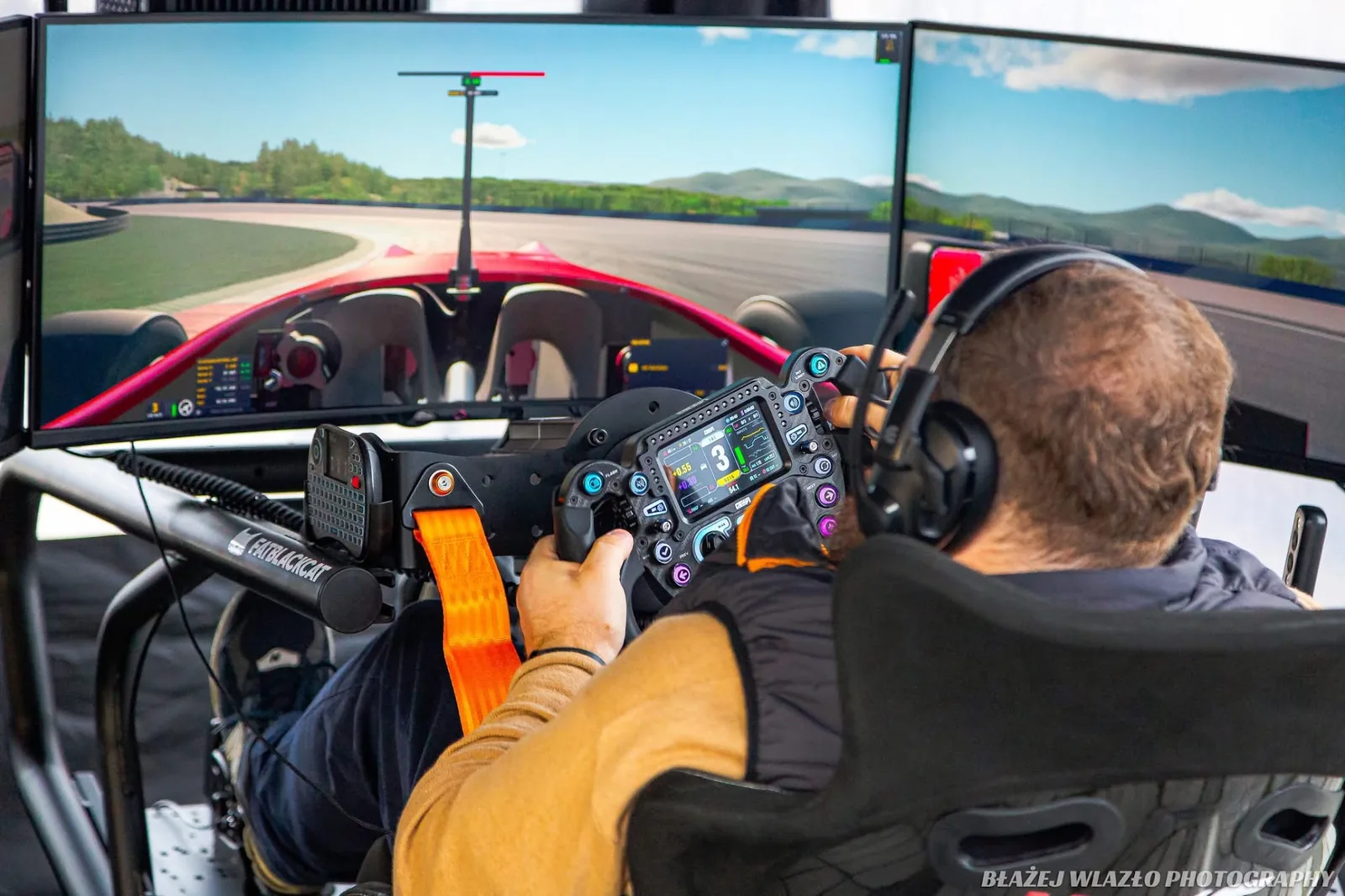 Driver at a FATBLACKCAT sim rig during a test session